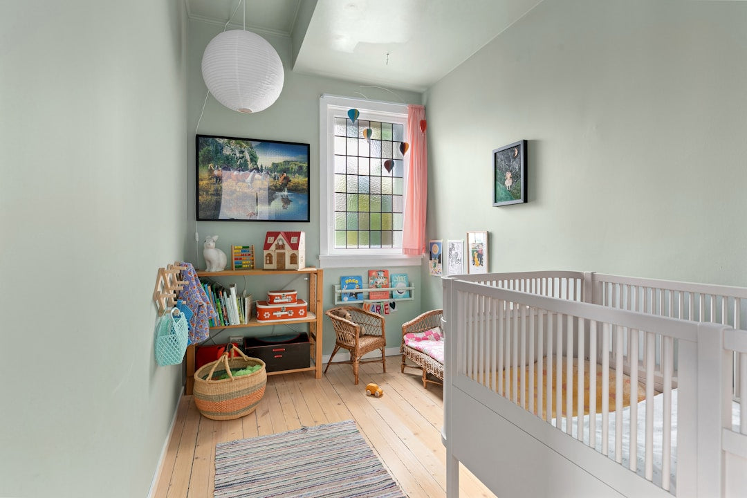 A bright, cozy baby's room with a white crib, soft bedding, and gentle natural light